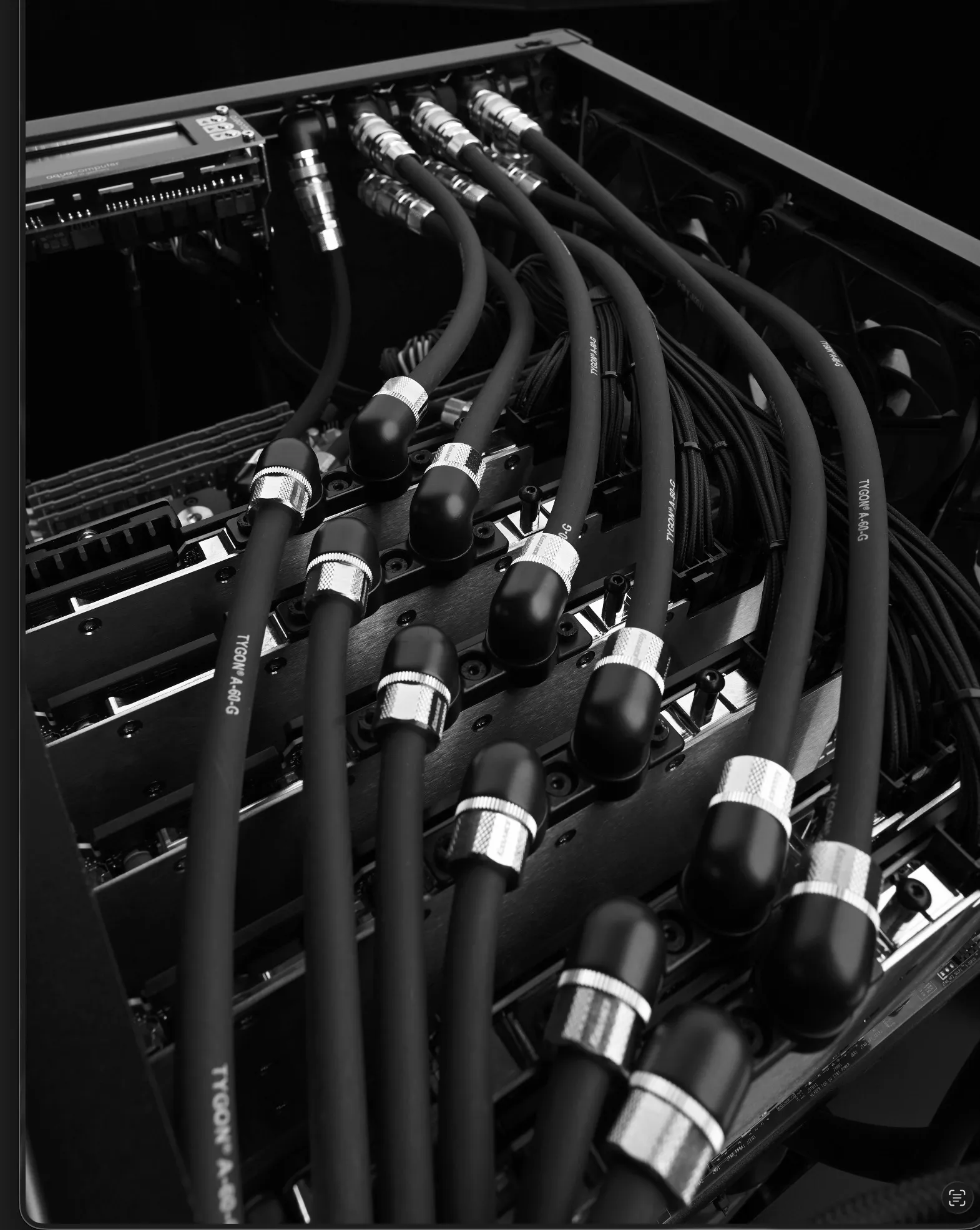 WS.COMPUTER special-edition interior — serial GPU water circuit: black Tygon lines with nickel couplings descending the chassis, coolant computer at the top left