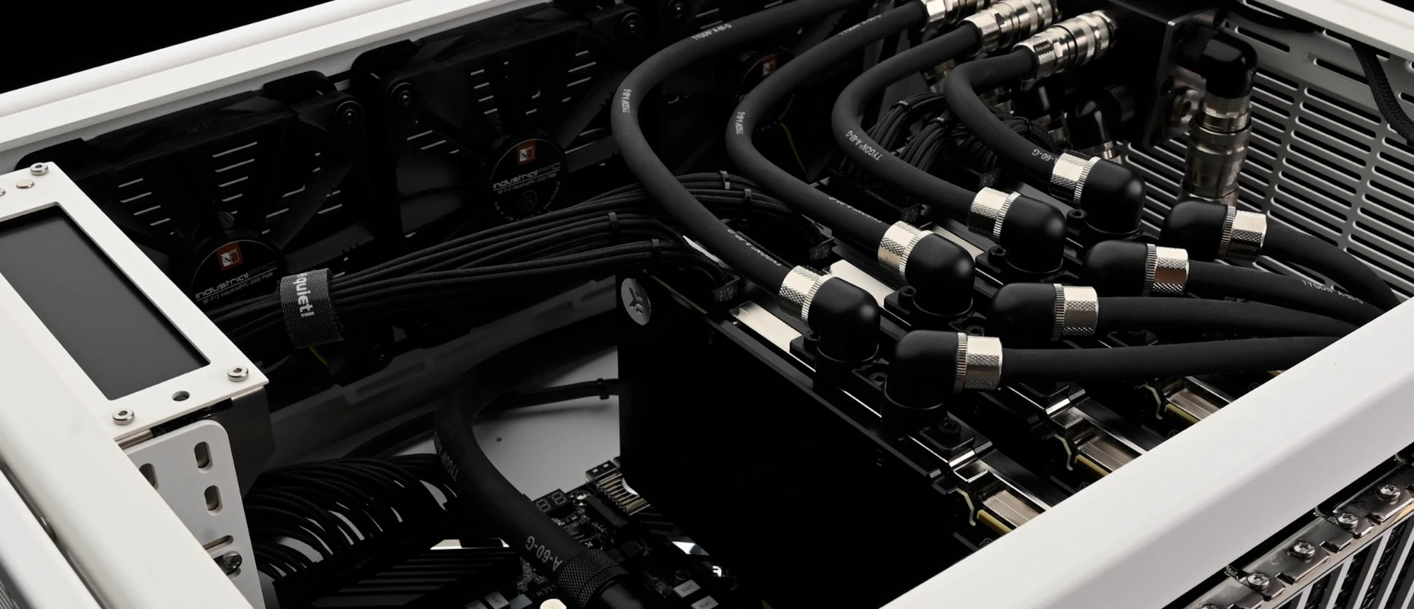 Inside WS.COMPUTER № 10004: four water-cooled GPU blocks on a nickel-railed PCIe rack, black Tygon loop tubing with knurled fittings, coolant LCD controller on the left
