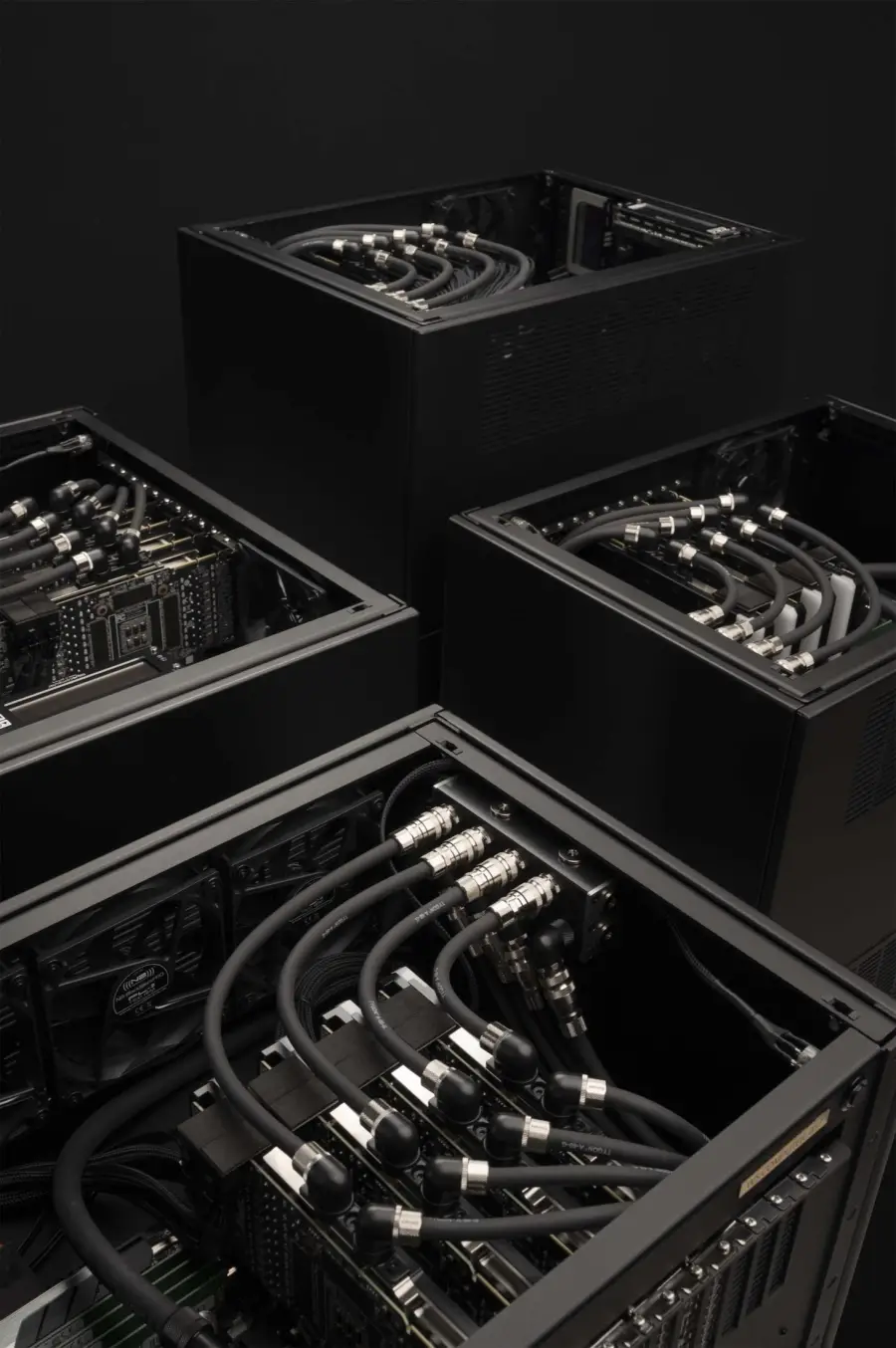 Four water-cooled WS.COMPUTER machines with open tops, GPU loop manifolds and chrome fittings